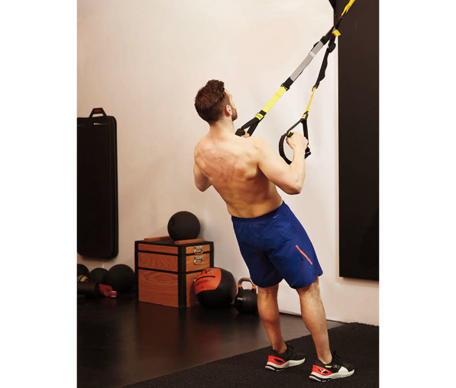 How to do it:<ul><li>Attach a suspension system trainer to a pullup bar.</li><li>Grab the handles so you’re looking up at the pullup bar.</li><li>Walk out until you can extend your arms without hitting the floor.</li><li>Hang from the straps so that your body forms a straight line.</li><li>Pull yourself up until the handles reach the sides of your chest.</li><li>Lower and repeat.</li></ul>