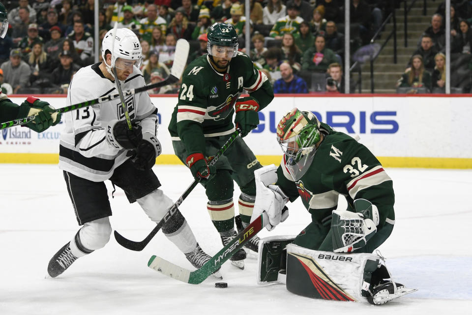 Minnesota Wild goalie Filip Gustavsson (32) blocks a shot as defenseman Matt Dumba (24) tries to clear Los Angeles Kings center Gabriel Vilardi (13) from the goal during the second period of an NHL hockey game Tuesday, Feb. 21, 2023, in St. Paul, Minn. (AP Photo/Craig Lassig)