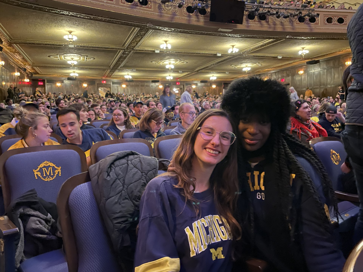 Alesandra Touchstone, left, and her best friend Michelle Bollini, both 24 of Clarkston score seats up front to watch the college national championship game at Michigan Theater in Ann Arbor on Monday, Jan. 8, 2024