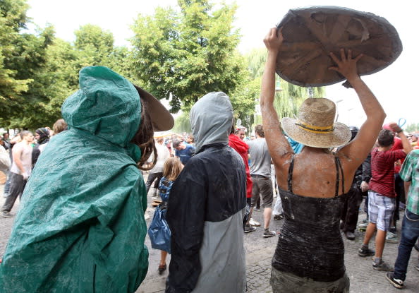 Participants fight in the the annual Vegetable Battle (Gemueseschlacht) on the Oberbaumbruecke on September 2, 2012 in Berlin, Germany. The event pits Kreuzberg district residents againts those of Friedrichshain for control of the Oberbaumbruecke (Oberbaum Bridge), and the two sides pelt each other with rotten vegetables, pet food, ketchup, chicken drumsticks, flour, water guns and styrofoam bats until one side has pushed the other from the bridge. Friedrichshain won the war, in revenge for Kreuzberg's victory the previous year. (Photo by Adam Berry/Getty Images)