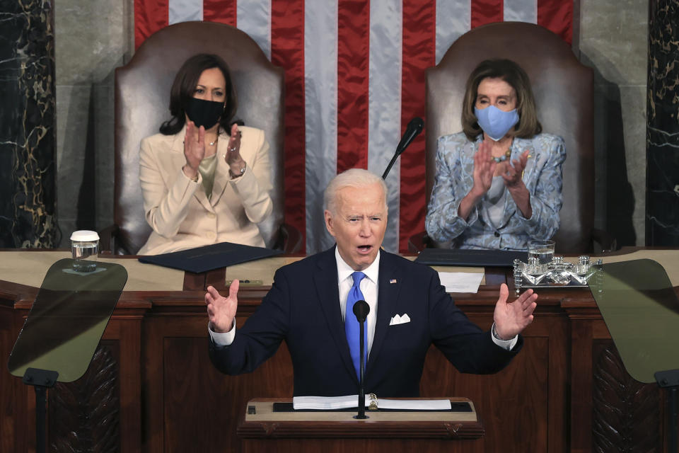 President Joe Biden addresses a joint session of Congress, Wednesday, April 28, 2021, in the House Chamber at the U.S. Capitol in Washington, as Vice President Kamala Harris, left, and House Speaker Nancy Pelosi of Calif., look on. (Chip Somodevilla/Pool via AP)