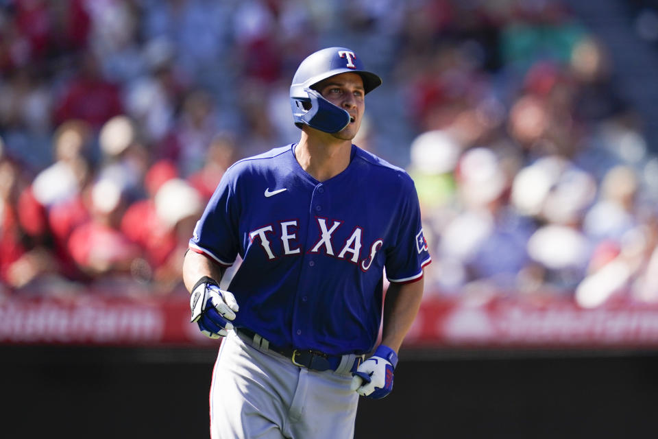 Texas Rangers' Corey Seager, right, runs the bases after hitting a home run during the fifth inning of a baseball game against the Los Angeles Angels in Anaheim, Calif., Sunday, Oct. 2, 2022. Marcus Seimen also scored. (AP Photo/Ashley Landis)