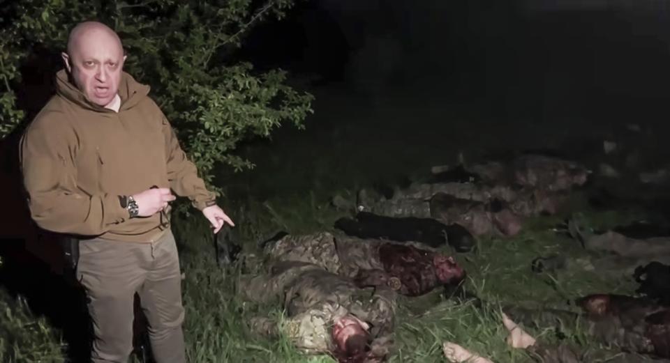 FILE In this image taken from a video released by Prigozhin Press Service on Friday, May 5, 2023, head of Wagner Group Yevgeny Prigozhin stands in front of multiple bodies lying on the ground in an unknown location. Prigozhin, the outspoken millionaire head of the private military contractor Wagner, has targeted Russian military leaders with expletive-riddled insults, blaming them for the failure to provide his troops with enough ammunition. (Prigozhin Press Service via AP, File)