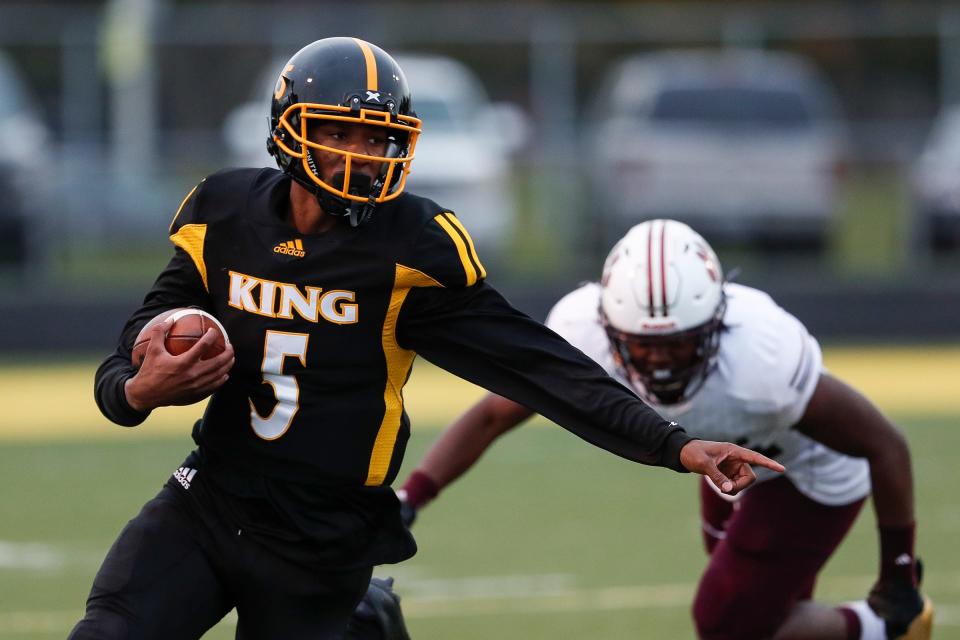 Detroit King quarterback Dequan Finn runs against River Rouge during the first half at King High School in Detroit, Friday, Oct. 26, 2018.