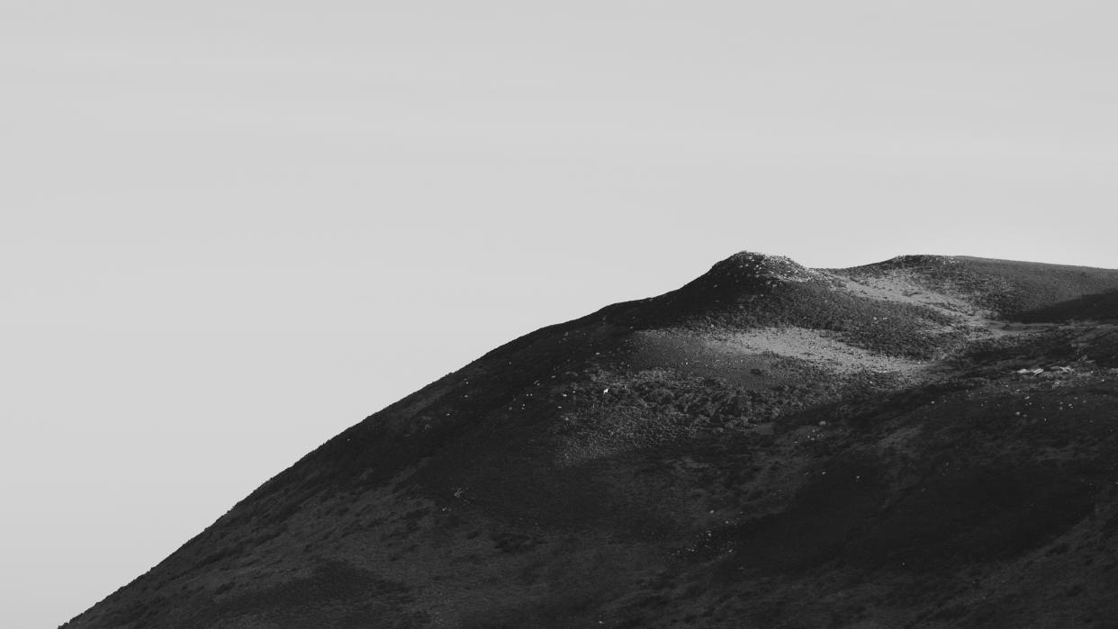  A black and white minimalist photograph of the Gower landscape in Rhossilli . 