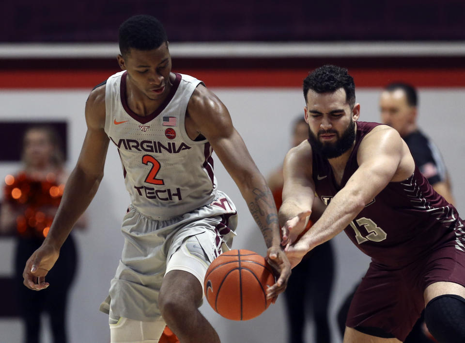 Virginia Tech's Landers Nolley II (2) has the ball tipped from behind by Maryland-Eastern Shore's Bryan Urrutia (13) in the first half of an NCAA college basketball game in Blacksburg, Va., Sunday, Dec. 29 2019. (Matt Gentry/The Roanoke Times via AP)