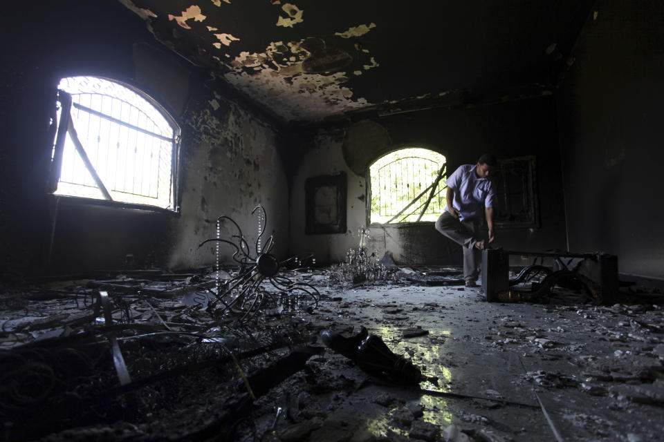 FILE - In this Sept. 13, 2012 file photo, a Libyan man investigates the inside of the U.S. Consulate after an attack that killed four Americans, including Ambassador Chris Stevens, on the night of Tuesday, Sept. 11, 2012, in Benghazi, Libya. (AP Photo/Mohammad Hannon, File)