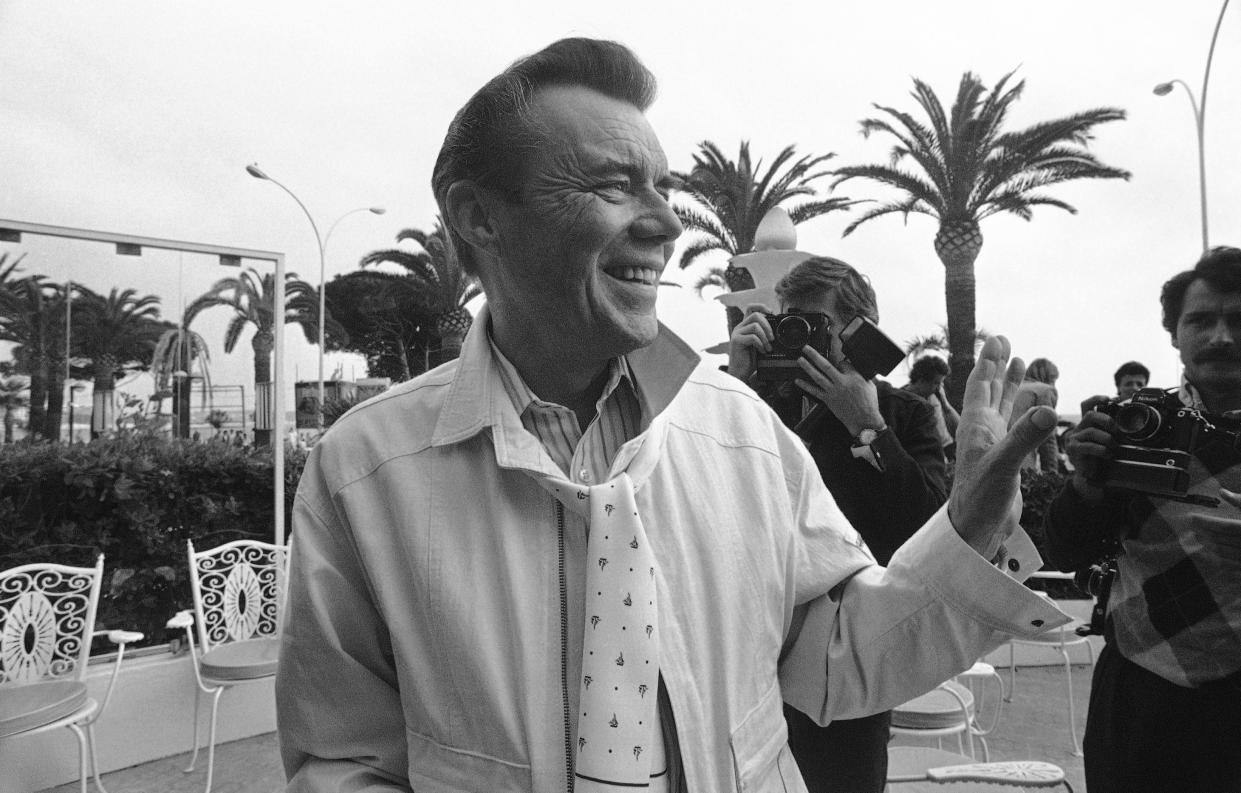 British actor Dirk Bogarde at the 37th International Cannes Film Festival are in front of the Carlton Hotel, near the Cannes Croisette on May 12, 1984. (AP Photo/Michel Lipchitz)