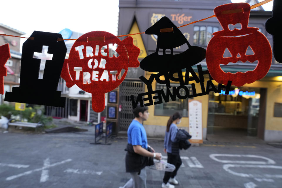 Halloween decorations are displayed near the scene of a deadly accident in Seoul, South Korea, Sunday, Oct. 30, 2022, following Saturday night's Halloween festivities. A mass of mostly young people celebrating Halloween festivities in Seoul became trapped and crushed as the crowd surged into a narrow alley, killing dozens of people and injuring dozens of others in South Korea's worst disaster in years. (AP Photo/Ahn Young-joon)