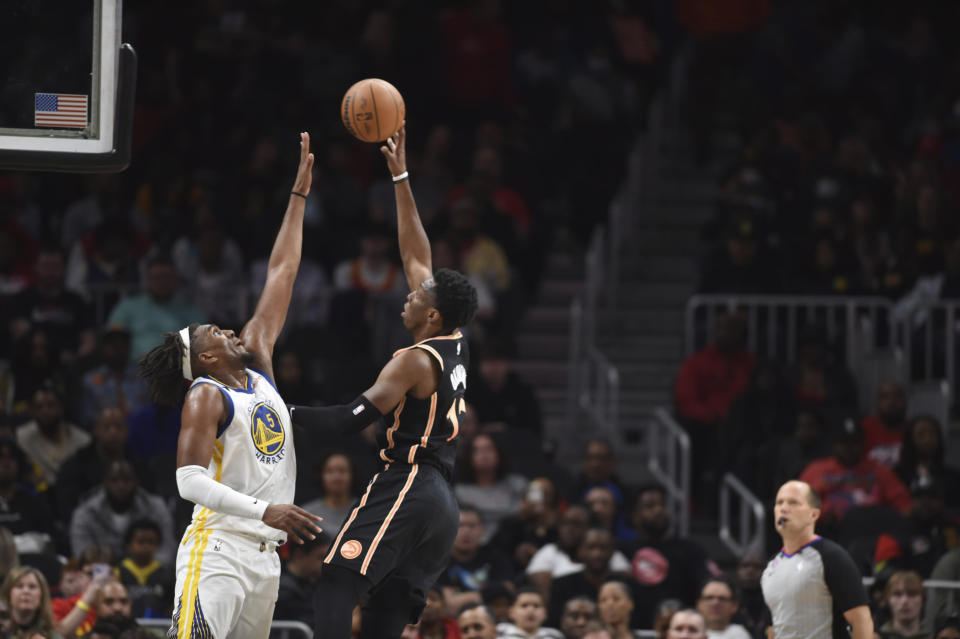 Atlanta Hawks forward Onyeka Okongwu, second from left, shoots against Golden State Warriors forward Kevon Looney, left, during the first half of an NBA basketball game, Friday, March 17, 2023, in Atlanta. (AP Photo/Hakim Wright Sr.)