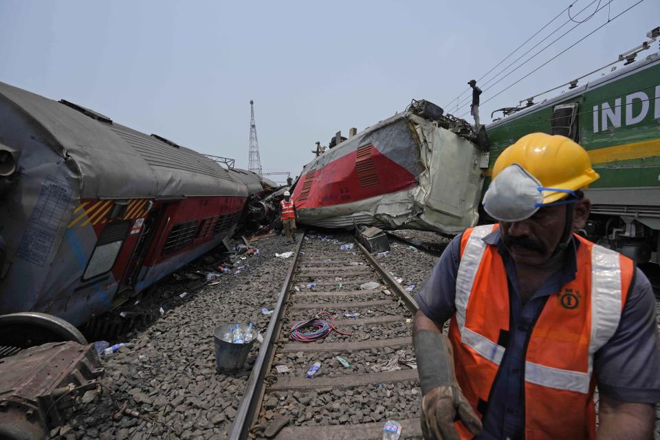 Rescuers work at the site of a passenger trains that derailed in Balasore district, in the eastern Indian state of Orissa, Saturday, June 3, 2023. Rescuers are wading through piles of debris and wreckage to pull out bodies and free people after two passenger trains derailed in India, killing more than 280 people and injuring hundreds as rail cars were flipped over and mangled in one of the country’s deadliest train crashes in decades. (AP Photo/Rafiq Maqbool)