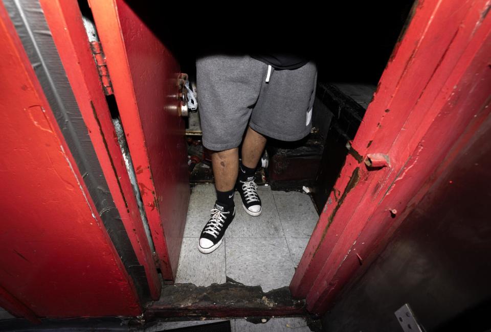 An employee mans the ticket booth at the Tiki Theater.