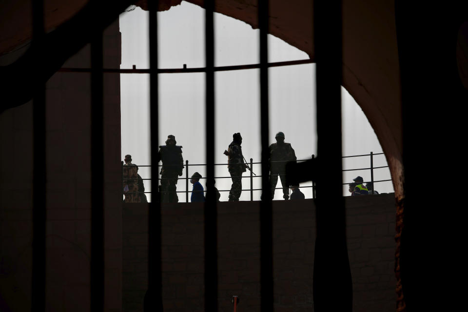 Indian security forces guard the historic Red Fort monument the day after it was stormed by protesting farmers in New Delhi, India, Wednesday, Jan.27, 2021. The protestors who have been demanding the repeal of new agricultural laws briefly took over the 17th-century fort on India's Republic Day, and hoisted a Sikh religious flag, in a profoundly symbolic challenge to Prime Minister Narendra Modi's Hindu-nationalist government. (AP Photo/Manish Swarup)