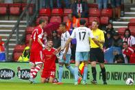 West Ham United's Joey O'Brien (centre) speaks with referee Andre Marriner after a tackle on Southampton's Adam Lallana (left)