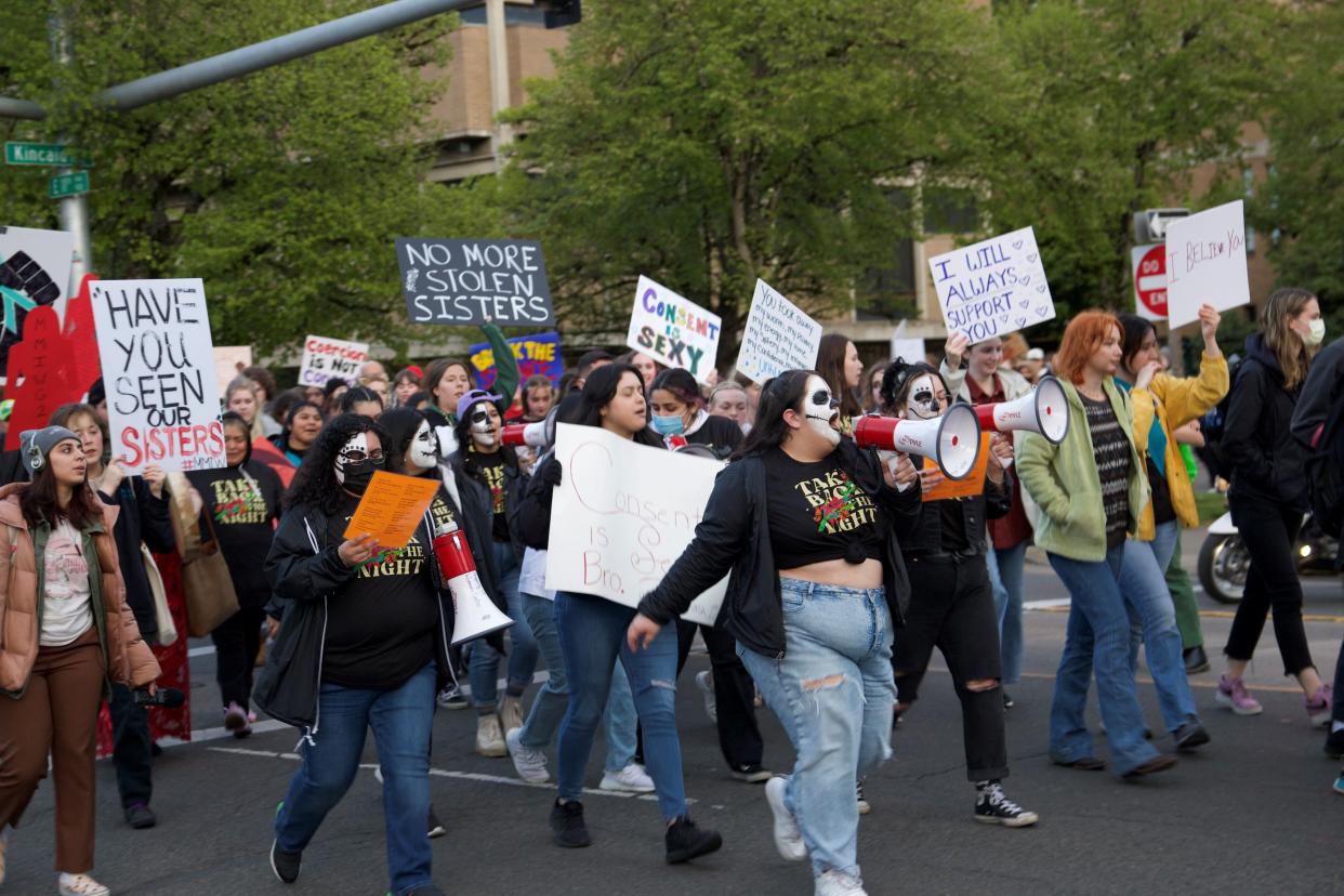 People gather in support of sexual and domestic violence awareness during a prior year's Take Back the Night Rally at the University of Oregon. The rally is put on by the Women's Center.