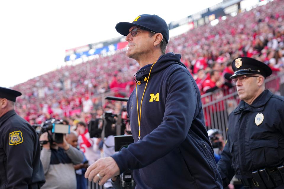 Michigan coach Jim Harbaugh walks onto the field prior to a game against Ohio State on Nov. 26.