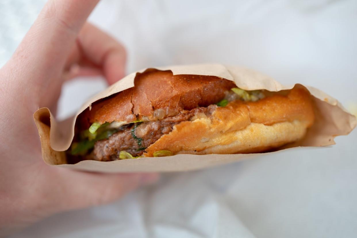 A person holds an Impossible brand meatless burger in California in 2021. <a href="https://www.gettyimages.com/detail/news-photo/close-up-of-human-hand-holding-impossible-brand-meatless-news-photo/1324263371?adppopup=true" rel="nofollow noopener" target="_blank" data-ylk="slk:Smith Collection/Gado/Getty Images;elm:context_link;itc:0;sec:content-canvas" class="link ">Smith Collection/Gado/Getty Images </a>