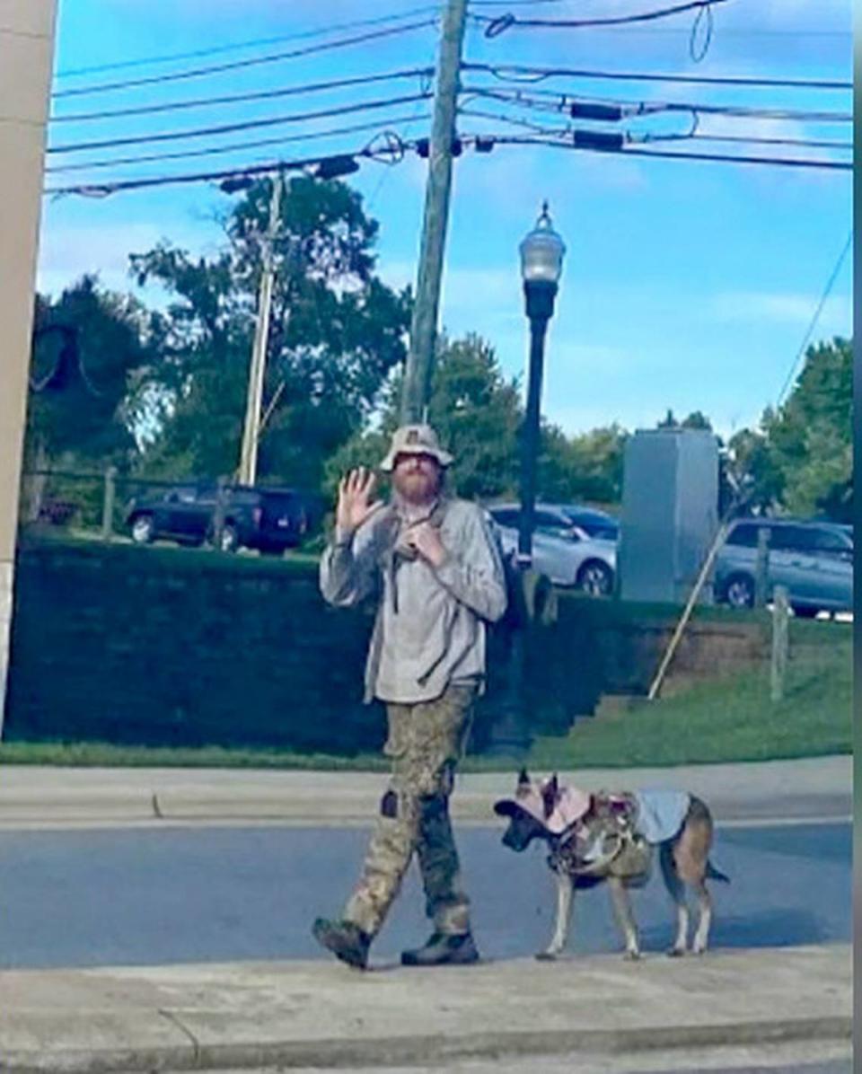 Former Kentucky National Guardsman Joshua Rohrer, an Iraq war veteran, and his service dog Sunshine walking in Gastonia, NC, in October 2021.