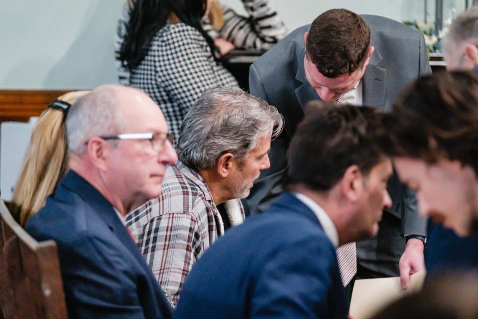 Gus Nickolas, center, speaks with an attorney Thursday before his arraingment in front of Carroll County Common Pleas Judge Michael V. Repella II in the Carroll County Courthouse.