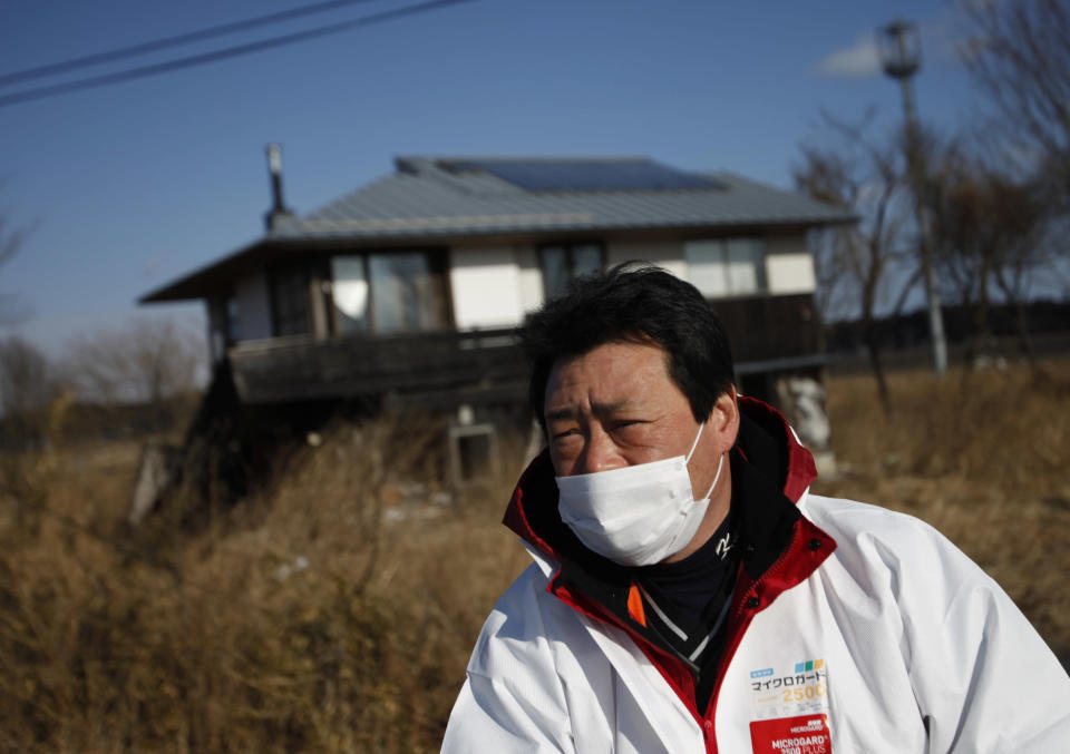 United Kennel Club Japan (UKC Japan) Representative Director Yasunori Hoso speaks in front of a destroyed house in Namie town, inside the 20km exclusion zone around the Fukushima Daiichi nuclear power plant, January 28, 2012. Dogs and cats that were abandoned in the Fukushima exclusion zone after last year's nuclear crisis have had to survive high radiation and a lack of food, and they are now struggling with the region's freezing winter weather. A 9.0-magnitude earthquake and massive tsunami on March 11 triggered the world's worst nuclear accident in 25 years and forced residents around the Fukushima Daiichi nuclear power plant to flee, with many of them having to leave behind their pets. Picture taken January 28, 2012. REUTERS/Issei Kato