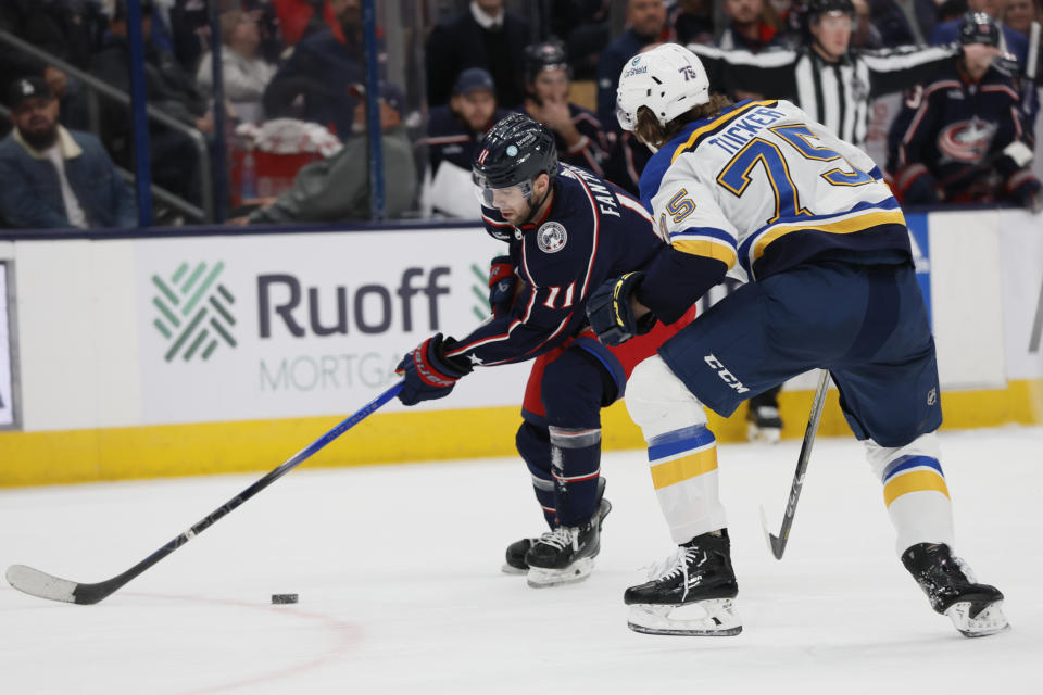 Columbus Blue Jackets' Adam Fantilli, left, tries to skate past St. Louis Blues' Tyler Tucker during the second period of an NHL hockey game Friday, Dec. 8, 2023, in Columbus, Ohio. (AP Photo/Jay LaPrete)