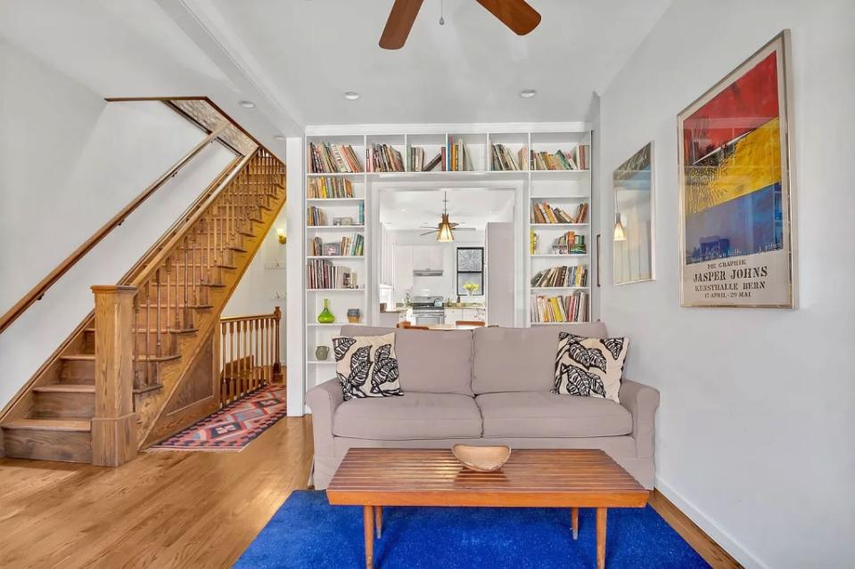 The formal living area with built-in bookshelves. Brenton Realty