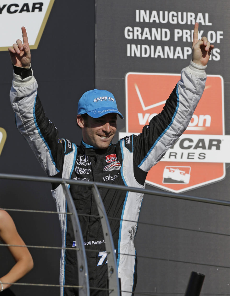 Simon Pagenaud, of France, celebrates as he walks to the podium after winning the inaugural Grand Prix of Indianapolis IndyCar auto race at the Indianapolis Motor Speedway in Indianapolis, Saturday, May 10, 2014. (AP Photo/Michael Conroy)