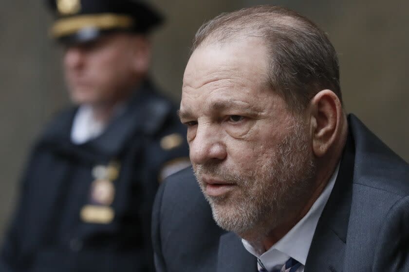 A close-up of an aging man with a police officer behind him