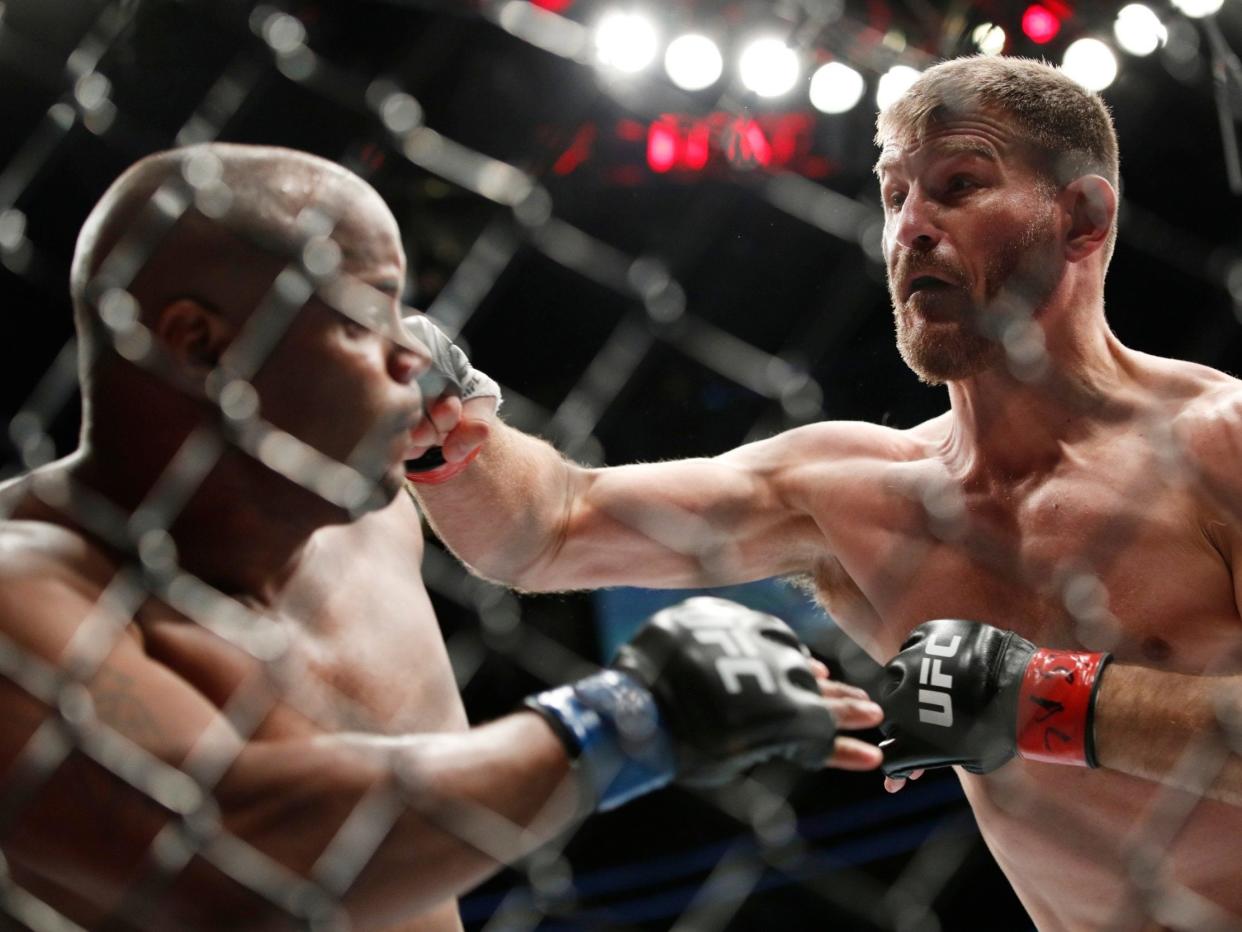 Stipe Miocic lands a right hand on Daniel Cormier: AP