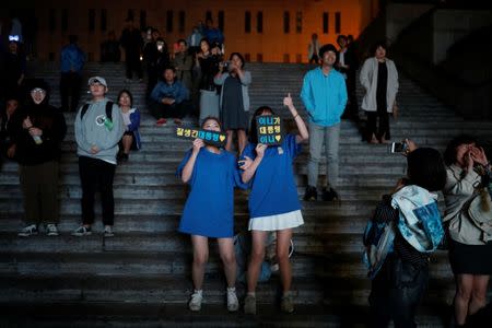 Supporters of South Korea's president-elect Moon Jae-in hold up signs at Gwanghwamun Square in Seoul, South Korea, May 10, 2017. REUTERS/Kim Hong-Ji