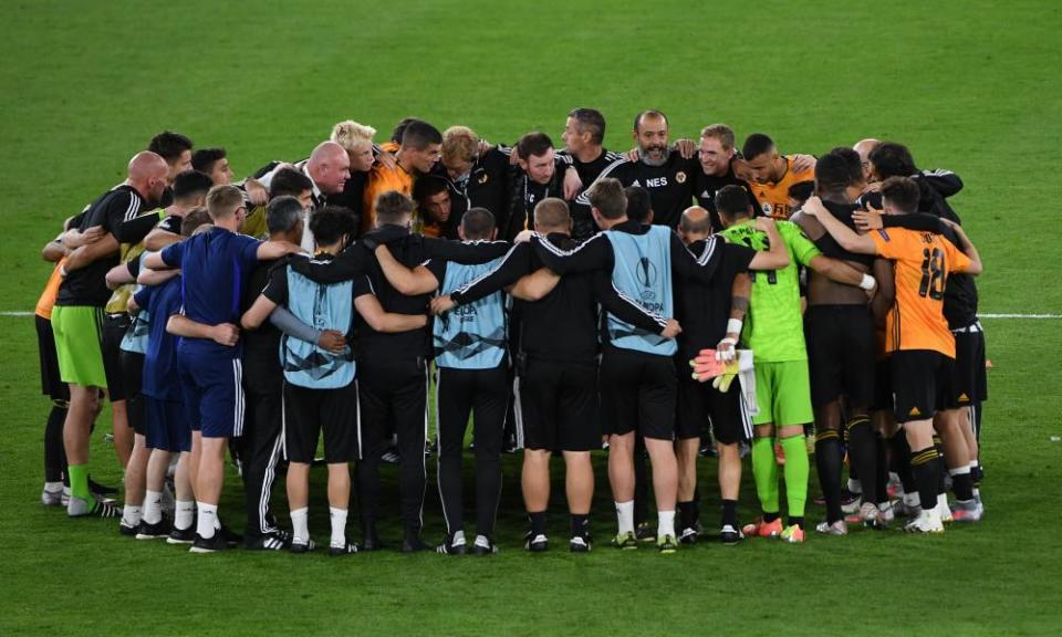 Wolves players and staff huddle after progress to Germany was secured.