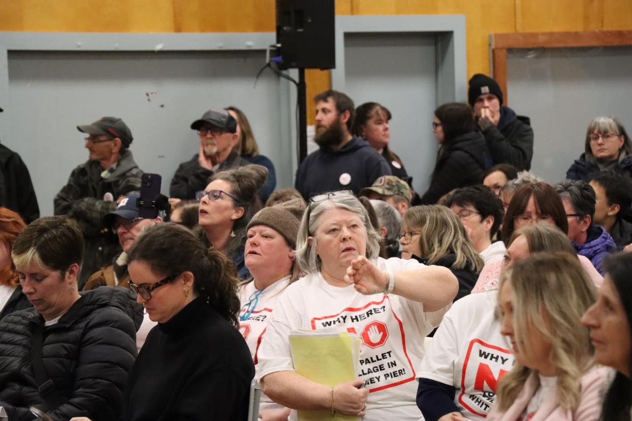 Many people in attendance at a meeting in Whitney Pier said they are opposed to the province's plans to create a village of 30 small shelters on a vacant lot in their community.  (Erin Pottie/CBC - image credit)