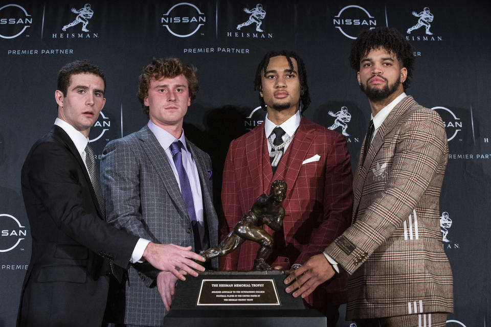 FILE - The Heisman trophy finalists, from left, Georgia quarterback Stetson Bennett, TCU quarterback Max Duggan, Ohio State quarterback C.J. Stroud and Southern California quarterback Caleb Williams, stand for a photo with the trophy before attending the award ceremony on Dec. 10, 2022, in New York. Duggan has thrown for 3,321 yards with 30 touchdowns and only four interceptions, and run for 404 yards with six more scores, heading into the Fiesta Bowl on Dec. 31. (AP Photo/Eduardo Munoz Alvarez, File)