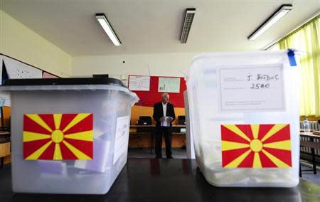 A man casts his ballots during presidential and early parliamentary elections in Skopje April 27, 2014. REUTERS/Ognen Teofilovski