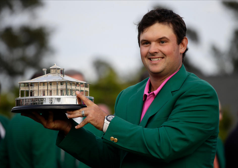 Patrick Reed holds the championship trophy after winning the Masters golf tournament Sunday, April 8, 2018, in Augusta, Ga. (AP)