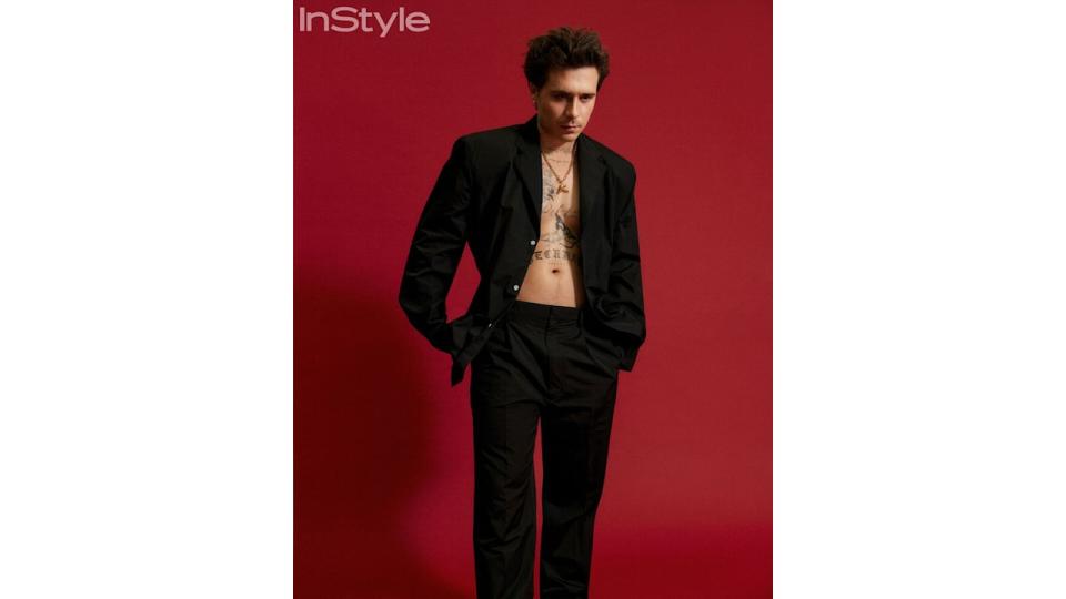 brooklyn beckham posing in black suit 