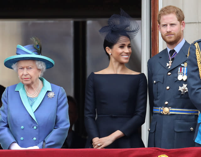 LONDON, ENGLAND – JULY 10: Queen Elizabeth II, Prince Harry, Duke of Sussex and Meghan, Duchess of Sussex on the balcony of Buckingham Palace as the Royal family attend events to mark the Centenary of the RAF on July 10, 2018 in London, England. <em>Photo by Chris Jackson/Getty Images.</em>