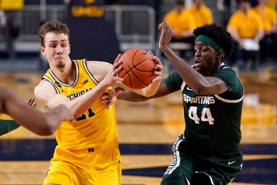 Michigan guard Franz Wagner (21) drives as Michigan State forward Gabe Brown (44) defends during the first half of an NCAA college basketball game Thursday, March 4, 2021, in Ann Arbor, Mich. (AP Photo/Carlos Osorio)