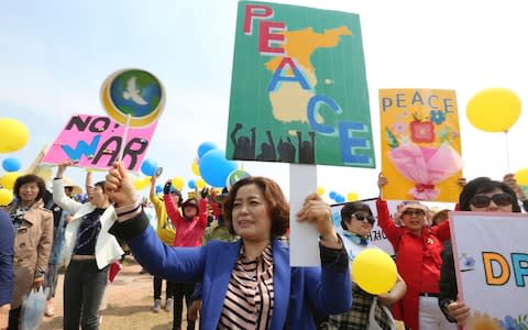 Members of the South Korean women's peace group stage a rally at the Imjingak Pavilion in Paju, near the border with North Korea - Credit: Ahn Young-joon/AP