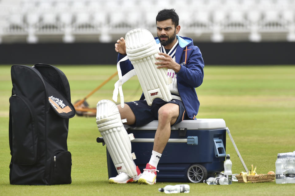 India captain Virat Kohli pads up during net practice prior to the first Test Match between England and India at Trent Bridge cricket ground in Nottingham, England, Monday, Aug. 2, 2021. (AP Photo/Rui Vieira)