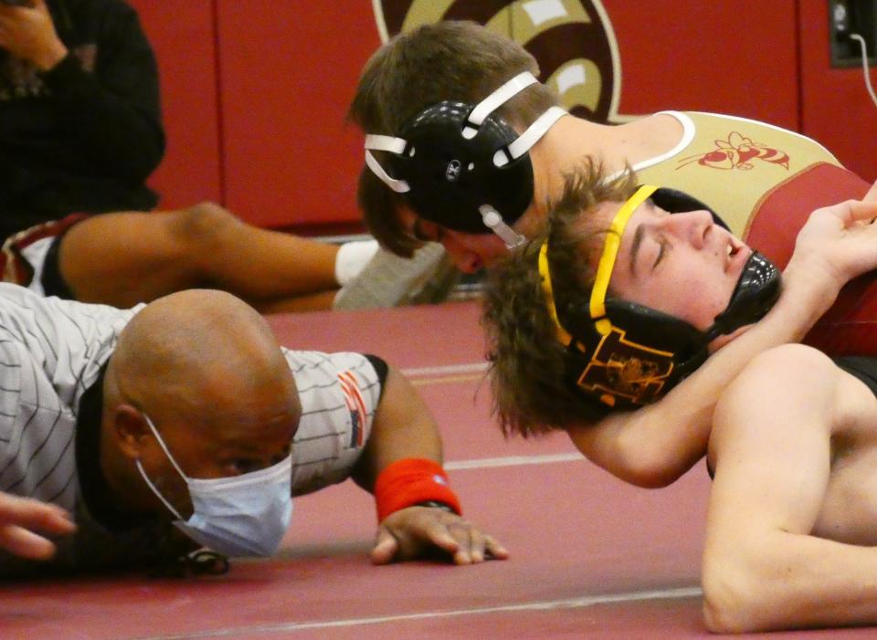 Licking Heights' Richard Storts nears a pin of Westerville North's Justin Workman in the 113-pound third-place match during the Licking Heights Invitational on Saturday, Jan. 15, 2022.