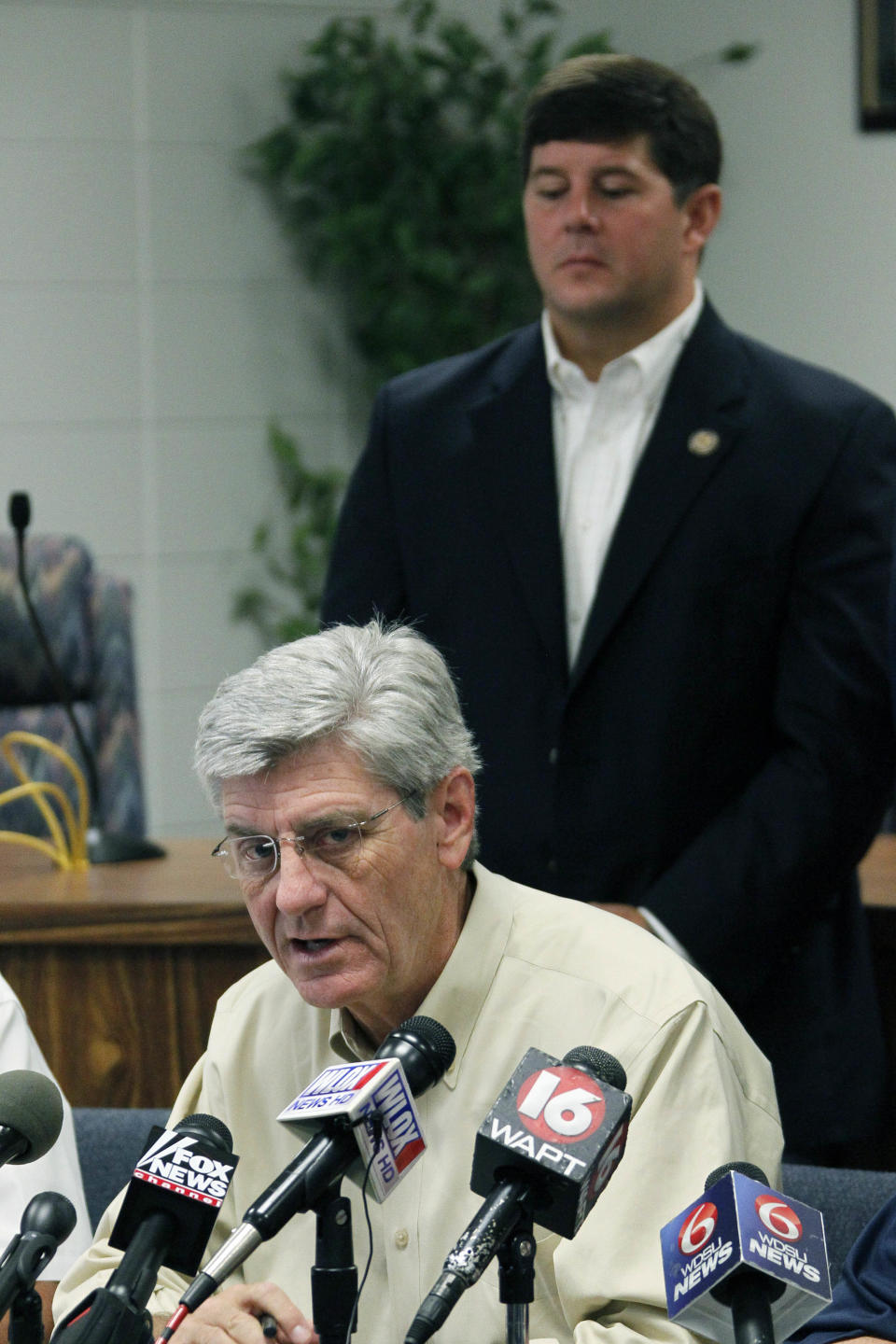 U.S. Rep. Steven Palazzo, R-Miss., rear, listens as Gov. Phil Bryant discusses Gulf Coast preparations for Tropical Storm Isaac during a news conference at the Harrison County Emergency Operations Center in Gulfport, Miss., Monday, Aug. 27, 2012. Palazzo is a Biloxi resident. (AP Photo/Rogelio V. Solis)