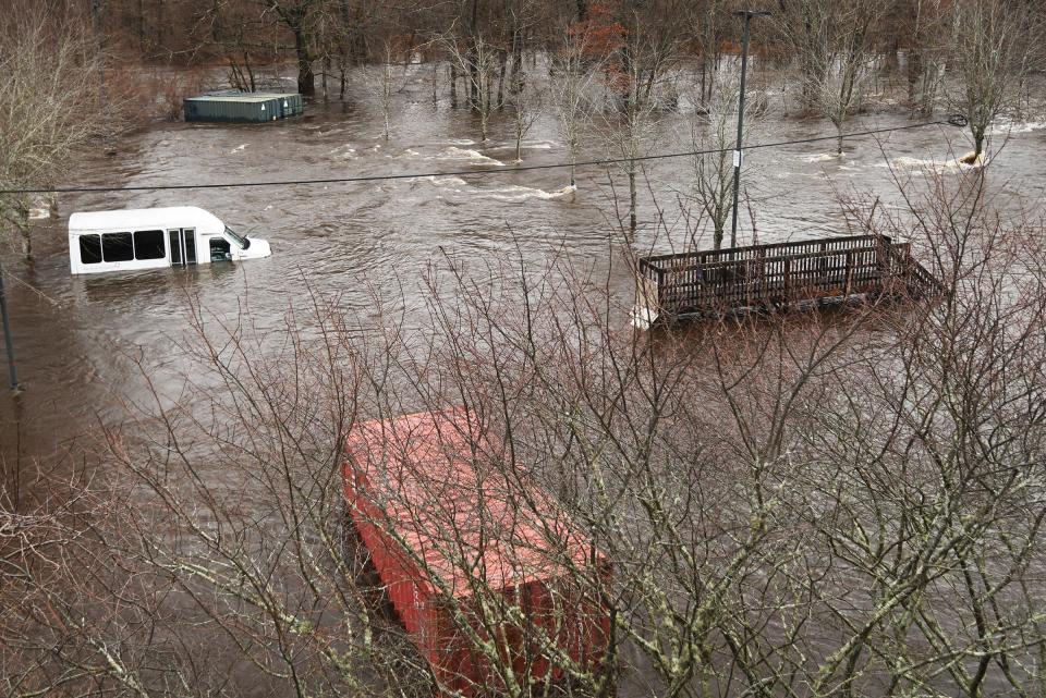 File photo of a van stuck in the January flooding by Backus Hospital.