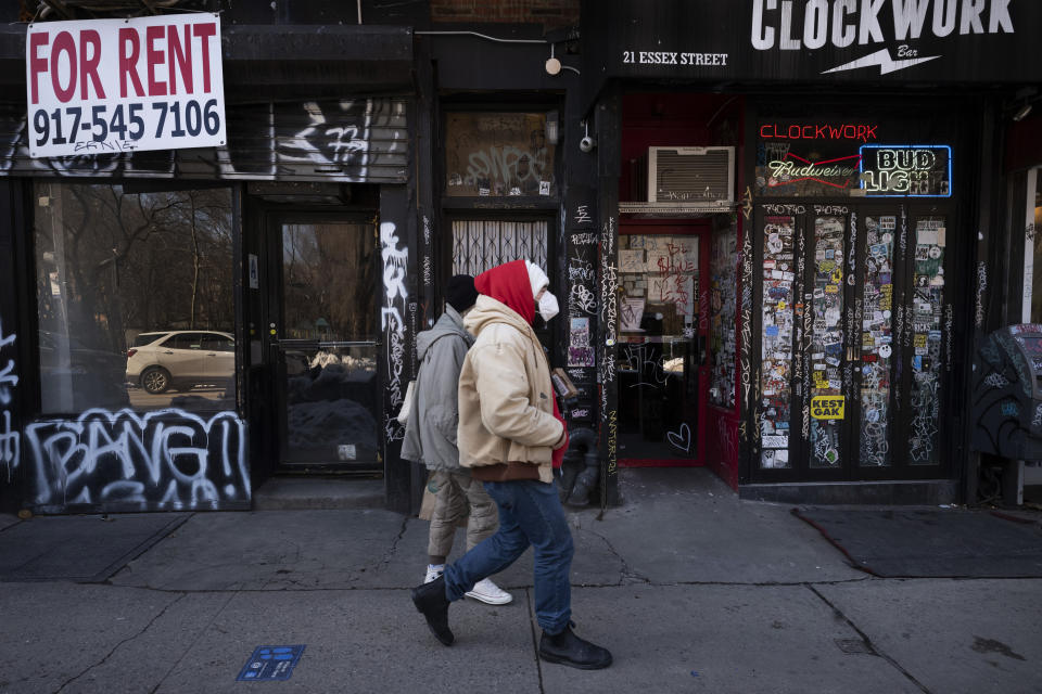 FILE - In this Feb. 8, 2021, file photo, a man walks by an empty retail store, left, that is available for rent during the coronavirus pandemic in New York. State governments will get a big influx of federal money from the $1.9 trillion COVID-19 relief package that could suddenly enable them to undertake large, expensive projects that have long been on their to-do lists, including high-speed internet for rural areas and drinking water improvements. (AP Photo/Mark Lennihan, File)