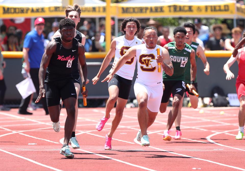 Simi Valley's Jaelon Barbarin takes the handoff from teammate Logan Pollard during the Division 2 boys 4x100 relay race at the the CIF-Southern Section Track and Field Championships at Moorpark High on Saturday, May 13, 2023. Simi Valley won the title in 41.51 seconds.