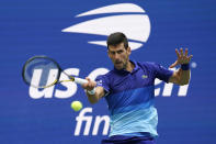 Novak Djokovic, of Serbia, returns a shot to Daniil Medvedev, of Russia, during the men's singles final of the US Open tennis championships, Sunday, Sept. 12, 2021, in New York. (AP Photo/John Minchillo)