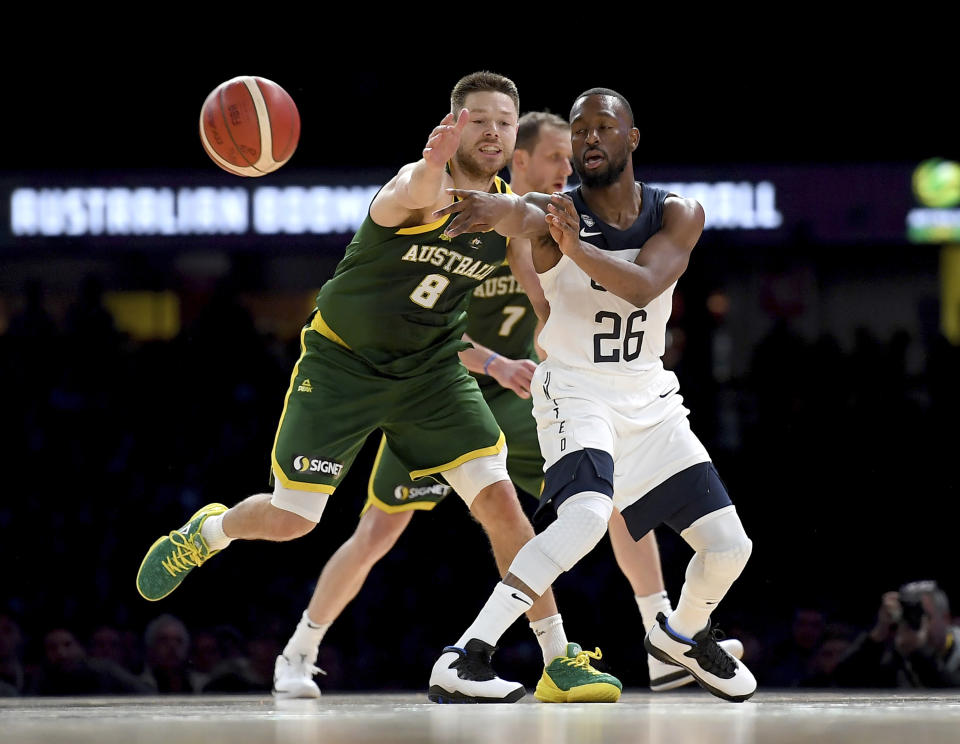 United States' Kemba Walker, right, and Australia's Matthew Dellavedova, left, battle for the ball during their exhibition basketball game in Melbourne, Thursday, Aug. 22, 2019. (AP Photo/Andy Brownbill)