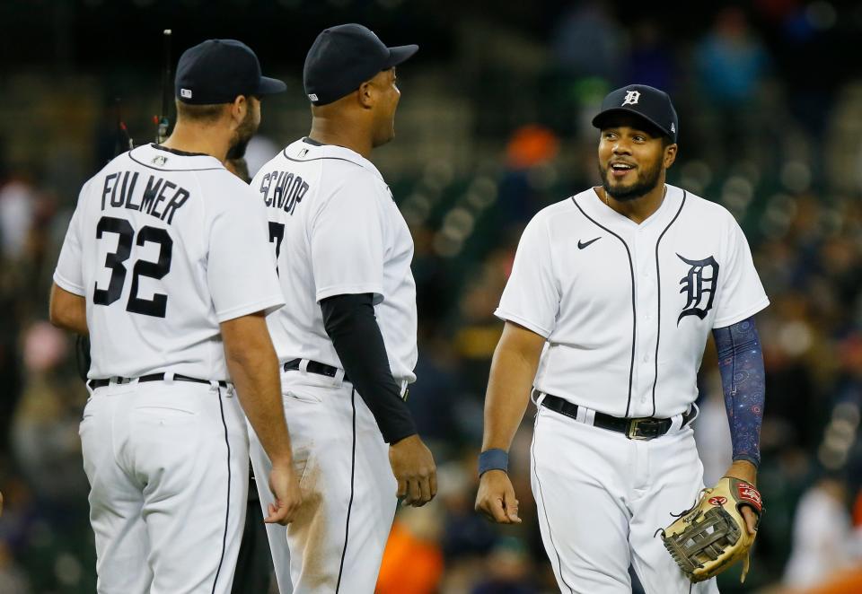 Detroit Tigers' Jeimer Candelario, right, smiles with Michael Fulmer and Jonathan Schoop after a 5-1 win over the Kansas City Royals in a baseball game Saturday, Sept. 25, 2021, in Detroit.