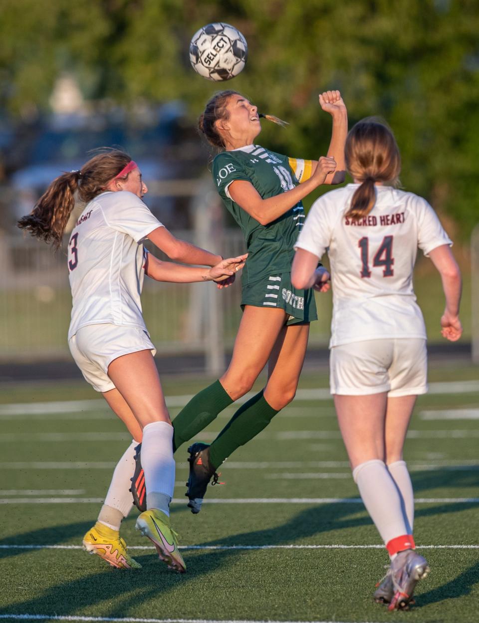 South Oldham's Betsy Huckaby, heads the ball against Sacred Heart defenders. Aug. 24, 2022