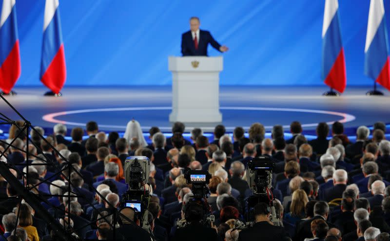 Officials listen to Russian President Putin's address to the Federal Assembly in Moscow